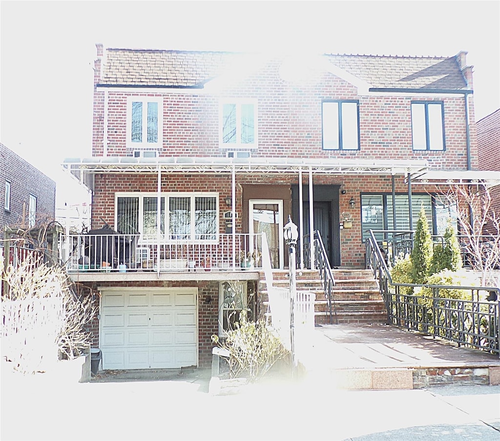 multi unit property featuring a porch and a garage