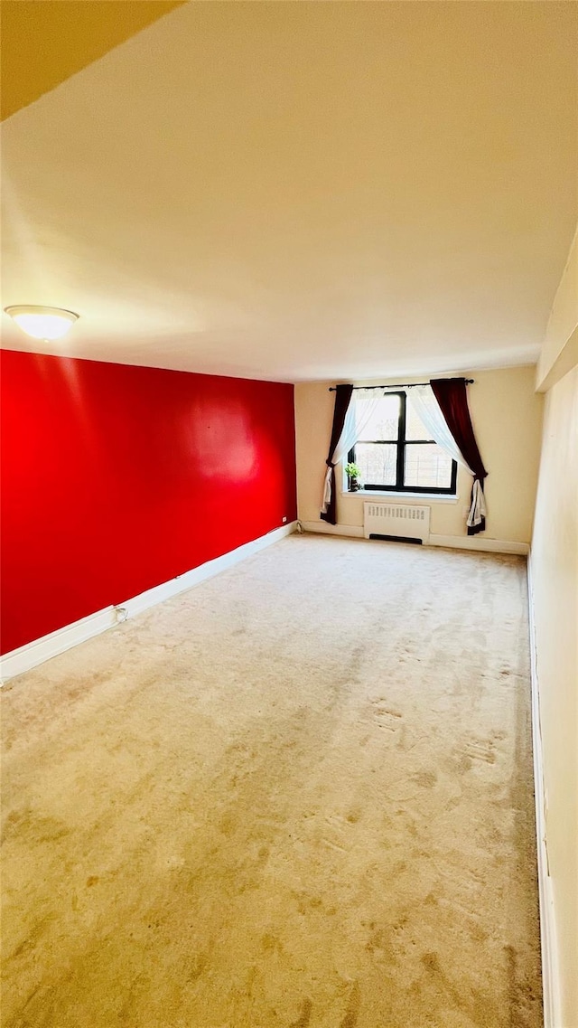 bonus room featuring radiator heating unit and carpet floors