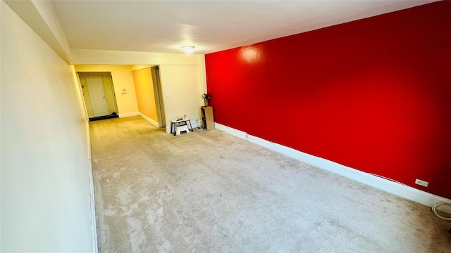 unfurnished room featuring light colored carpet