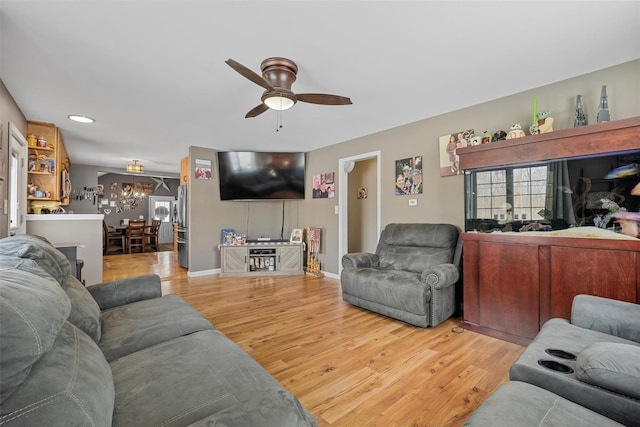 living room featuring hardwood / wood-style flooring, plenty of natural light, and ceiling fan