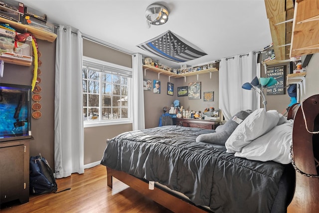 bedroom with wood-type flooring