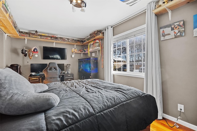 bedroom with wood-type flooring