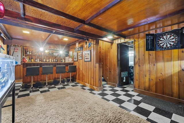 bar with beam ceiling, wood ceiling, and wood walls