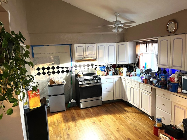 kitchen with ceiling fan, white cabinets, light wood-type flooring, and stainless steel appliances