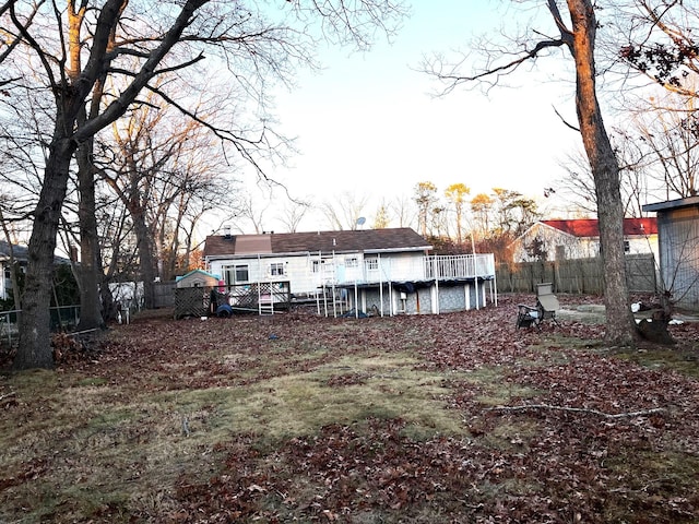 back of house with a swimming pool side deck