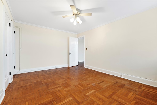 spare room with ceiling fan, parquet flooring, and crown molding