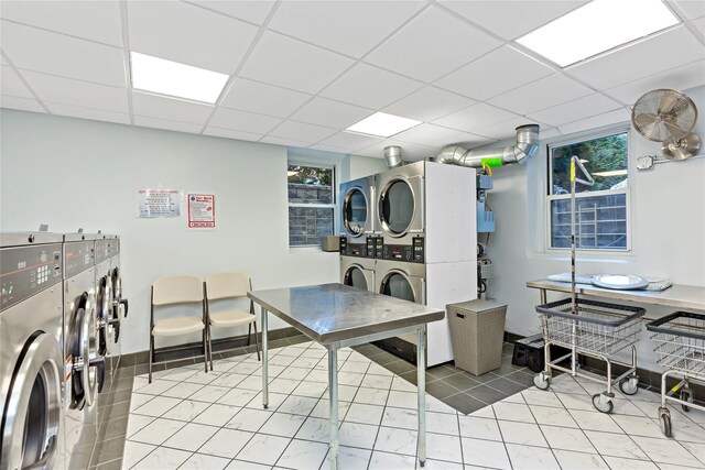 washroom featuring stacked washer / drying machine, washing machine and clothes dryer, and light tile patterned floors