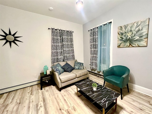 living room with hardwood / wood-style floors and a baseboard heating unit