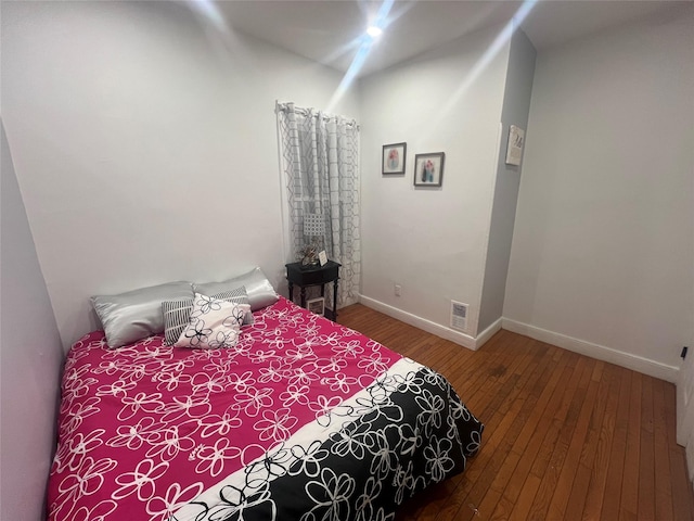 bedroom with hardwood / wood-style floors