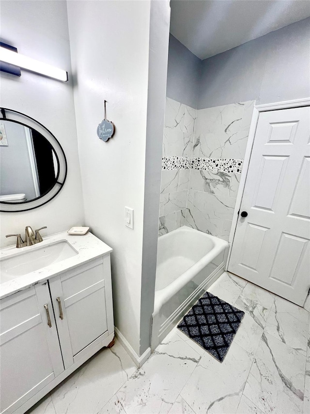 bathroom featuring tiled shower / bath combo and vanity