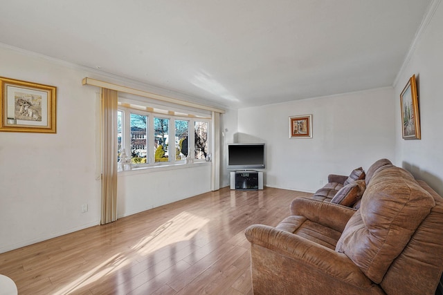 living room featuring crown molding and light wood-type flooring