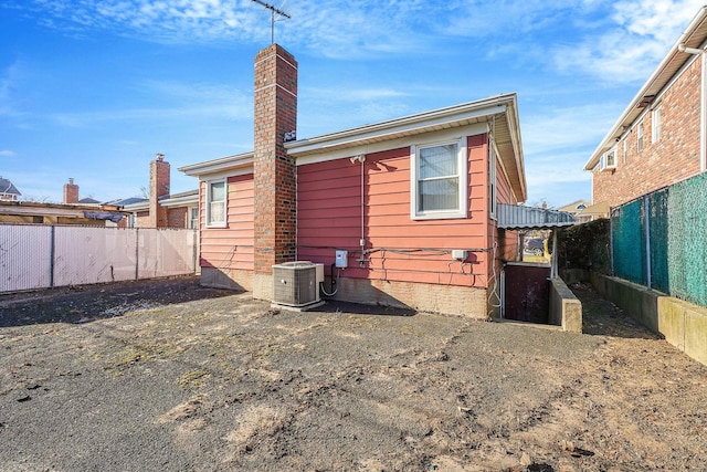 rear view of house featuring central AC unit