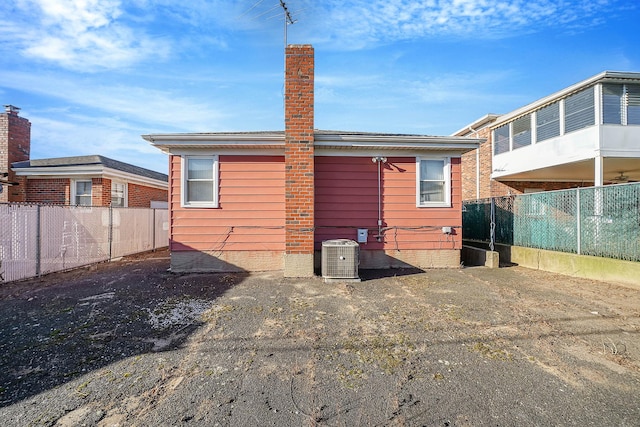 back of house featuring central AC unit