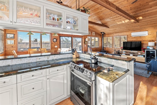 kitchen featuring stainless steel range with electric stovetop, wooden ceiling, white cabinetry, and wooden walls