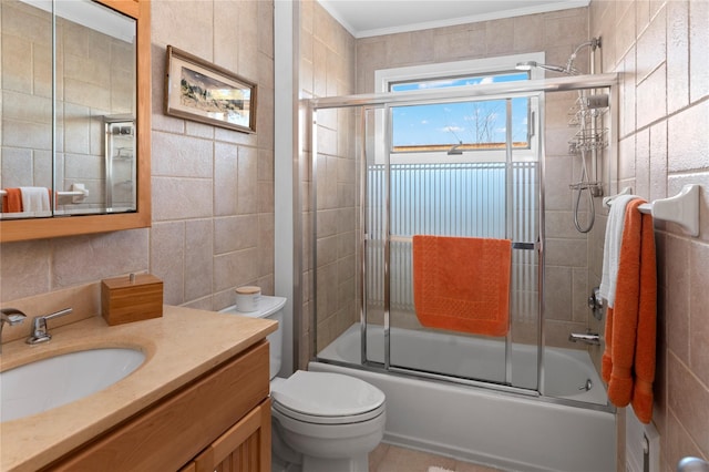 full bathroom with toilet, tile walls, enclosed tub / shower combo, and vanity