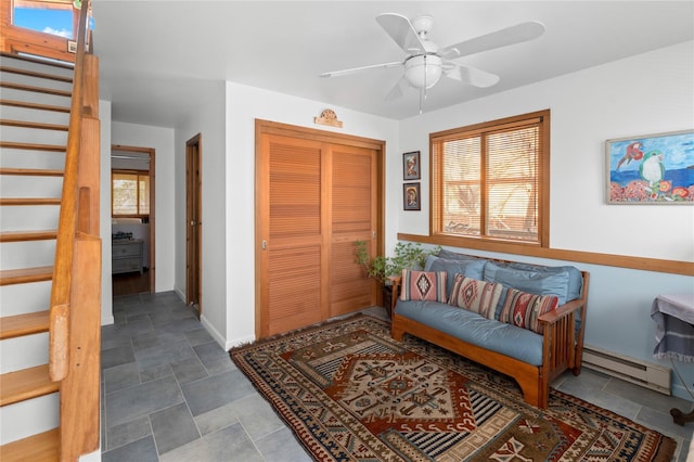 interior space featuring ceiling fan and a baseboard heating unit