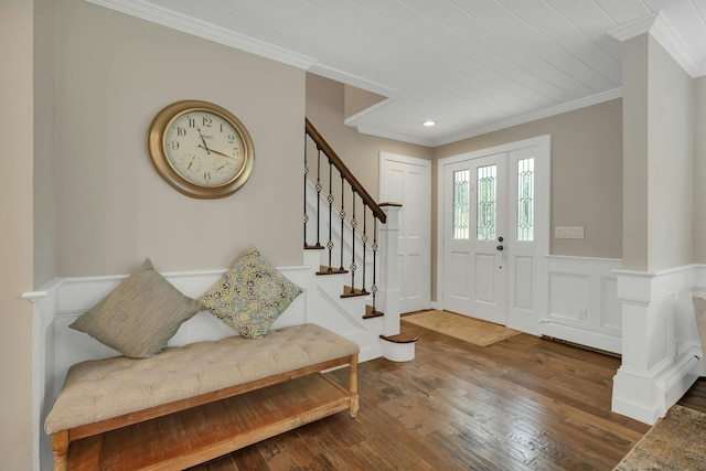 foyer entrance featuring wood-type flooring and ornamental molding