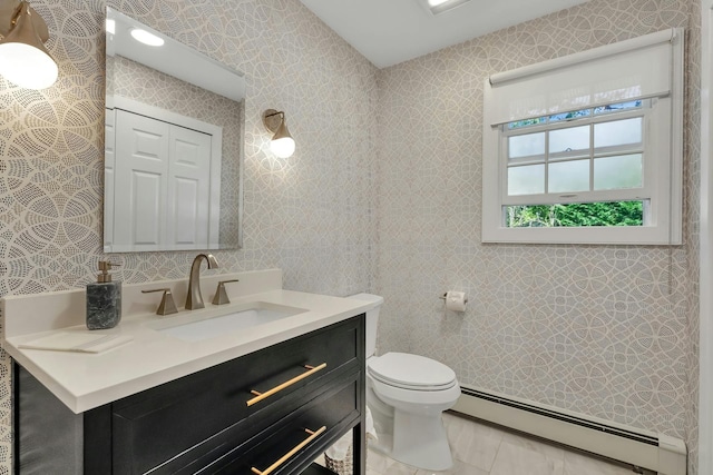 bathroom featuring vanity, toilet, and a baseboard heating unit