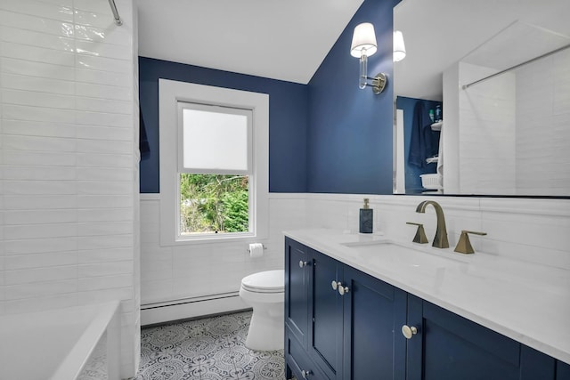 bathroom with vanity, baseboard heating, tile walls, tile patterned flooring, and toilet