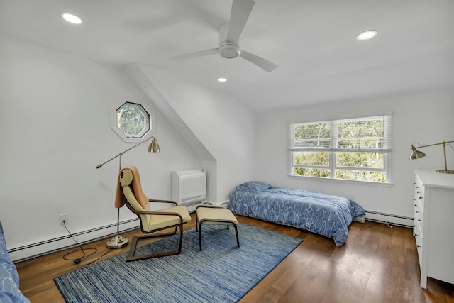 bedroom with ceiling fan, vaulted ceiling, dark wood-type flooring, and a baseboard heating unit