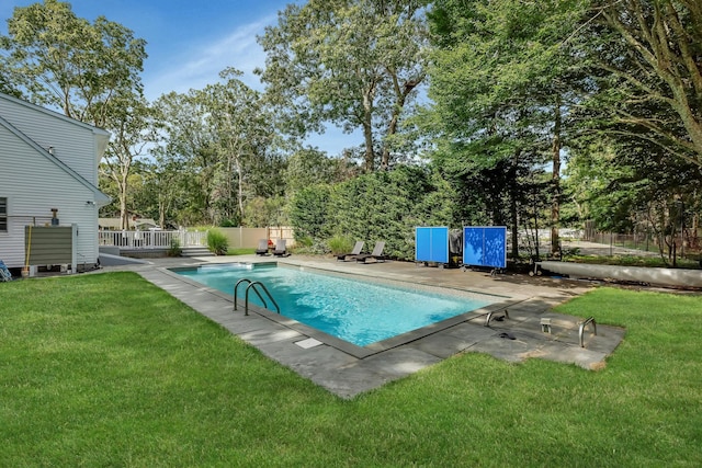 view of swimming pool with a lawn