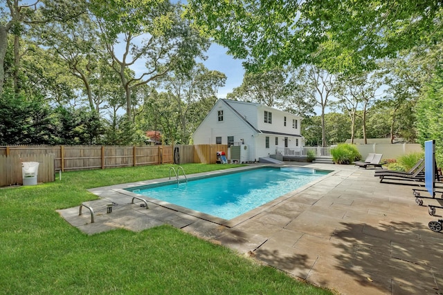 view of swimming pool featuring a patio and a lawn