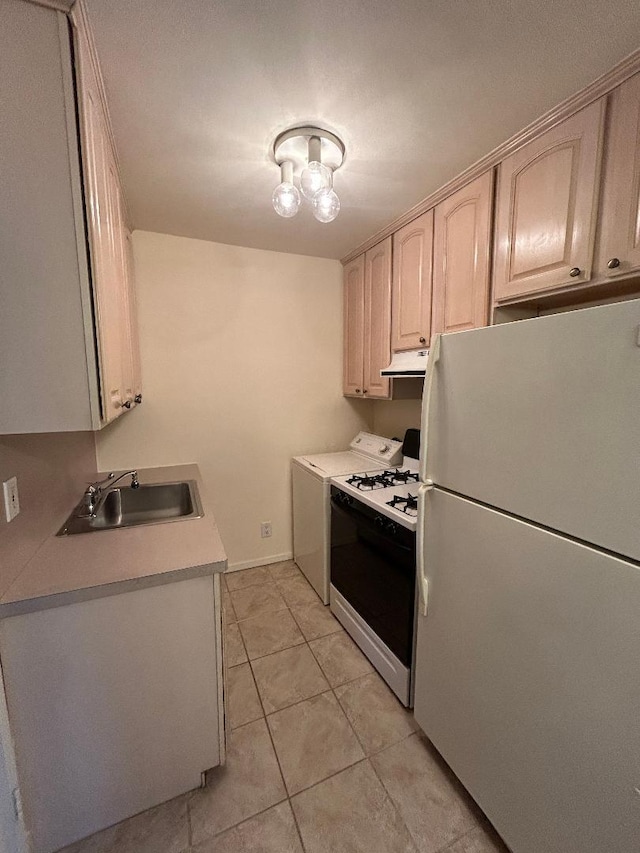 kitchen with light brown cabinetry, white appliances, sink, light tile patterned floors, and washer / clothes dryer