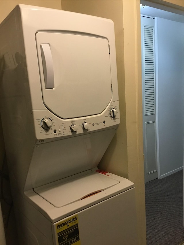 washroom with stacked washer and dryer