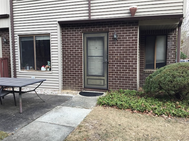 entrance to property featuring a patio area