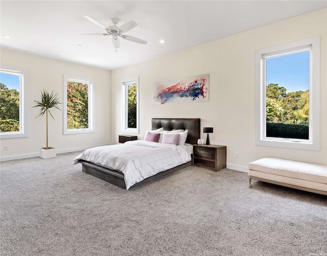 bedroom featuring multiple windows, ceiling fan, and carpet floors