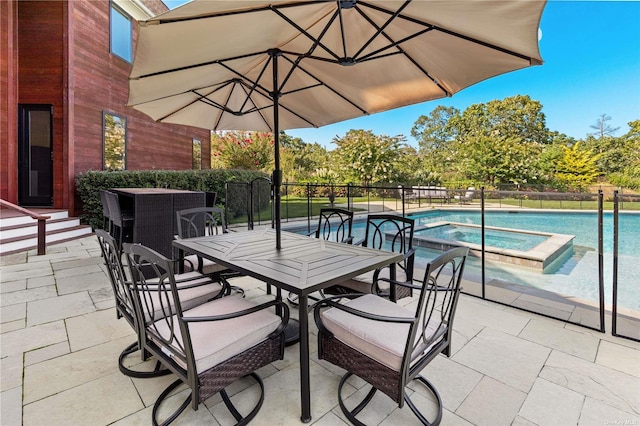 view of patio with a pool with hot tub