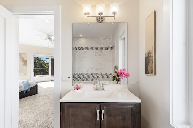 bathroom with a shower, ceiling fan, and vanity