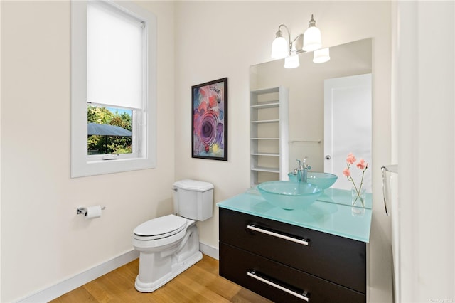 bathroom with vanity, hardwood / wood-style flooring, and toilet