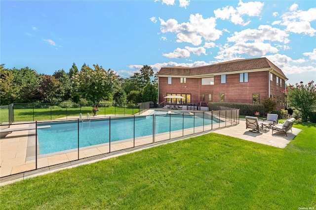 view of swimming pool with a yard and a patio area