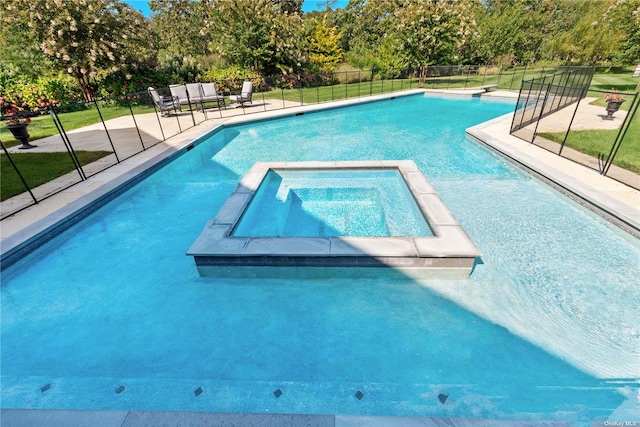 view of swimming pool with an in ground hot tub and a yard