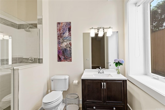 bathroom with toilet, vanity, and walk in shower