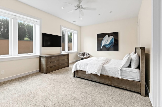 bedroom with ceiling fan and light colored carpet