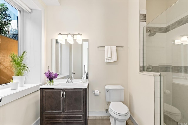 bathroom featuring vanity, a shower with shower door, and toilet