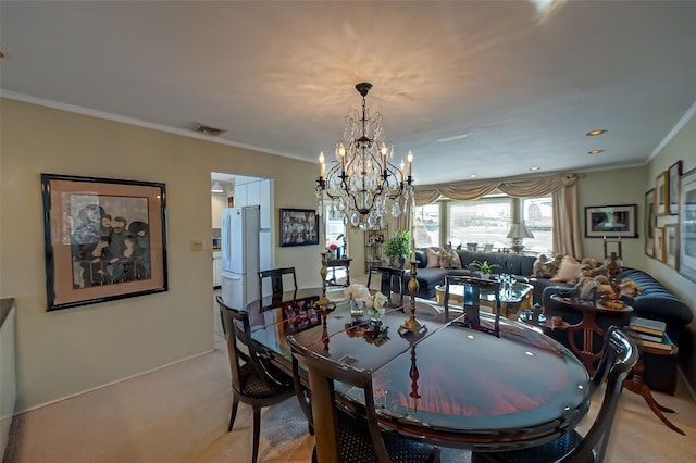 dining area with light colored carpet, ornamental molding, and a chandelier