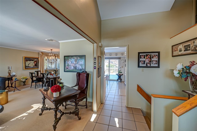 hallway with an inviting chandelier, ornamental molding, and light tile patterned flooring