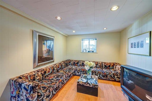 living room with hardwood / wood-style floors and crown molding