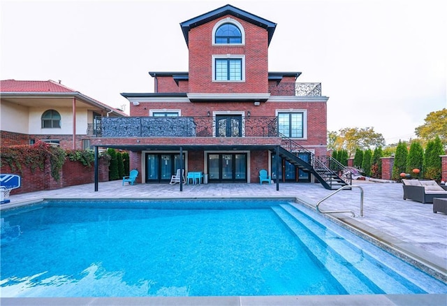 view of swimming pool with a patio area, an outdoor hangout area, and french doors