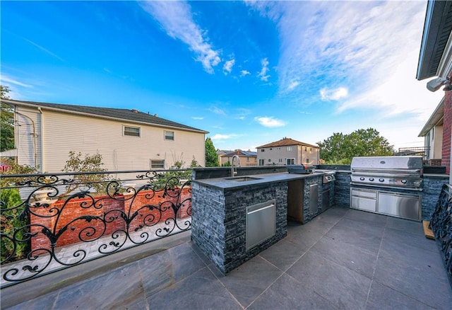 view of patio featuring area for grilling and sink