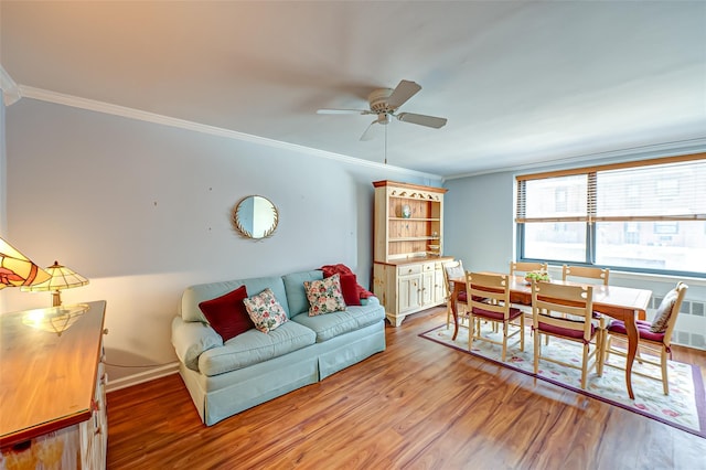 living room with ceiling fan, ornamental molding, radiator heating unit, and hardwood / wood-style floors