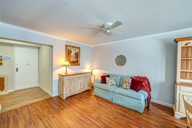 living room with crown molding, ceiling fan, and light hardwood / wood-style flooring