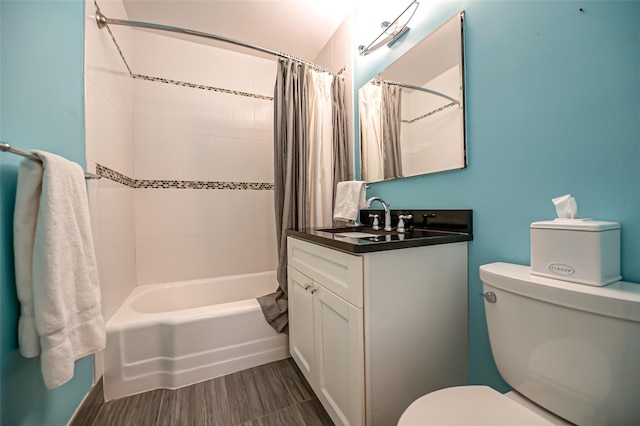 full bathroom with vanity, shower / tub combo, and toilet