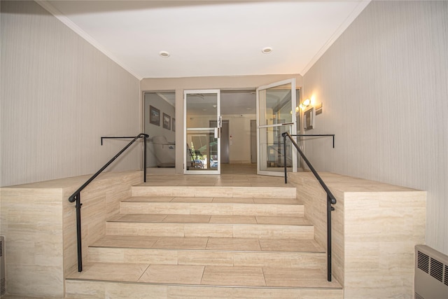 staircase featuring crown molding and radiator