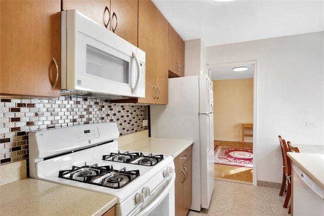 kitchen with backsplash and white appliances