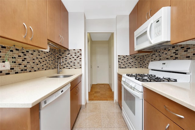 kitchen featuring decorative backsplash, sink, and white appliances