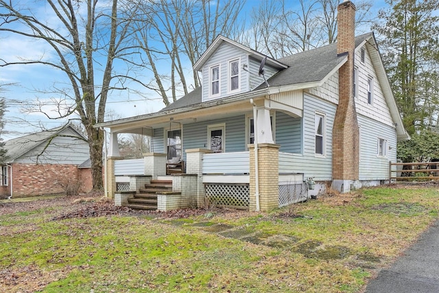 bungalow-style home featuring a front yard and a porch